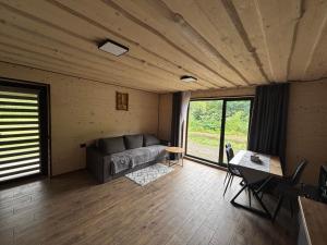 a living room with a couch and a table at Тиша біля річки in Izki