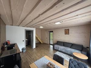 a living room with a couch and a wooden ceiling at Тиша біля річки in Izki