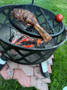a steak cooking on a grill with flames at Sollidsvägen 1 F in Bro