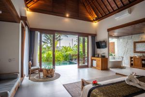 a bedroom with two beds and a pool at Dewi Kunti Villa in Tegalalang