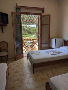 a bedroom with a bed and a sliding glass door at Maistrali in Galissas