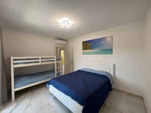 a bedroom with two bunk beds and a blue bed at Don Cesar Palace in Bibione +165 photos