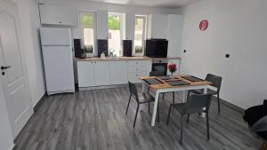 a kitchen with a table and chairs and a refrigerator at Casa Magurele 5 in Măgurele