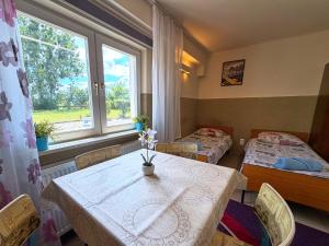 a room with two beds and a table and a window at Hostel Relax in Warsaw