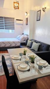 a living room with a table and a couch at Kim's Cozy Place - Parthenon Residences in Cebu City