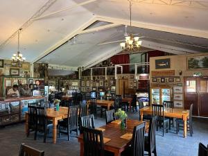 a restaurant with wooden tables and chairs in a room at Lanseria Country Estate in Lanseria