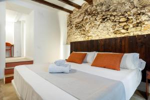 a bedroom with a large bed with towels on it at Port Apartsuite in Tarragona