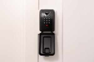 a black remote control is attached to a door at Port Apartsuite in Tarragona
