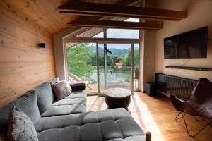 a living room with a couch and a large window at Great Lake in Nová Baňa