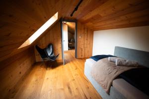 a bedroom with a bed and a chair in a room at Great Lake in Nová Baňa
