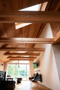 a living room with wooden ceilings and a large window at Great Lake in Nová Baňa +10 photos