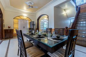 a dining room with a table and chairs at SaffronStays StoneVilla in Shimla