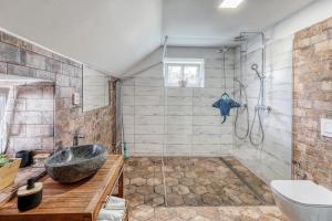a bathroom with a sink and a shower at Roubenka Kailas in Červená Voda +57 photos