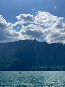 a large body of water with mountains in the background at Sweet Home in Belley