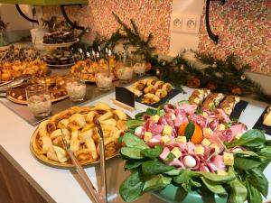 a buffet with many different types of food on a table at Sweet Home in Belley