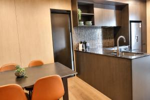 a kitchen with a table and a sink at Relax on Remarkable in Queenstown