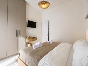 a bedroom with a bed with two white pillows at Thea Stays in Kato Gouves