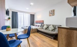 a living room with a couch and a table at Loft New Gudauri LT in Gudauri