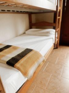 two bunk beds in a room with a tile floor at Alberg rural torre del baró in Sant Llorenç de Morunys