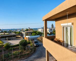 a balcony of a house with a view of a parking lot at Thea Stays in Kato Gouves