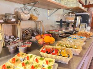 a buffet with many baskets of food on a counter at Penzion Larion in Kráľová Lehota