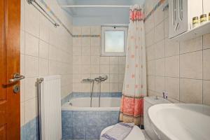 a bathroom with a tub and a toilet and a sink at Dimitra Apartments Zakros Village in Kato Zakros +162 photos