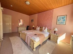 a bedroom with a bed and two night stands and lamps at Ferienwohnung Heidi in Annaberg-Buchholz