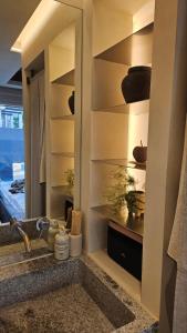 a bathroom with a sink and a mirror over a counter at 한옥스테이 서유재 in Ch'unch'ŏn-yŏk