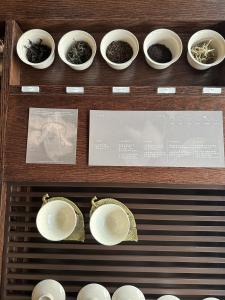 a display of bowls and plates on a shelf at 한옥스테이 서유재 in Ch'unch'ŏn-yŏk