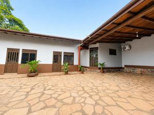 a patio of a house with plants in it at Eagle Nest in Namulanda