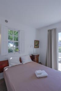 a bedroom with a white bed with two towels on it at Casa La Breña La Palma in Breña Baja +39 photos