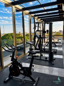 a gym with treadmills and ellipticals in a building at Hotel Lunamar in Beira