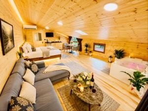 a living room with a couch and a table at Ayder Royal River Resorts - Bungalows & Hotels in Çamlıhemşin