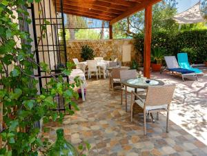a patio with a table and chairs on a patio at Marea Blanca in Porto Cesareo