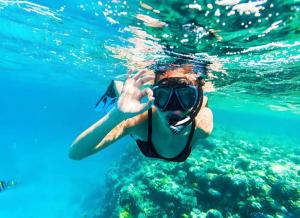 a person in the water wearing a snorkel at Marea Blanca in Porto Cesareo