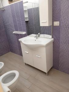 a bathroom with a sink and a toilet at Marea Blanca in Porto Cesareo +18 photos