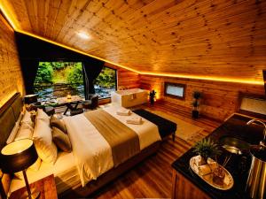 a bedroom with a large bed in a wooden room at Ayder Royal River Resorts - Bungalows & Hotels in Çamlıhemşin +32 photos