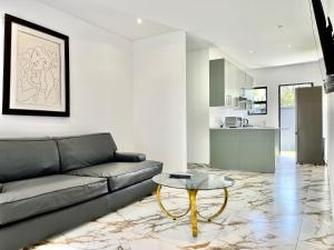 a living room with a couch and a table at Number 15 Jadde Apartments in Sandton