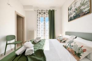 a bedroom with a bed and a chair and a window at Domus dell'Angelo in Monte SantʼAngelo