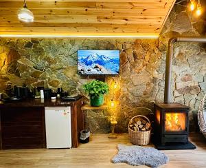 a room with a stone wall with a stove at Ayder Royal River Resorts - Bungalows & Hotels in Çamlıhemşin