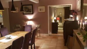 a dining room with a wooden table and chairs at Chambre D'hôtes De La Vaine in Cartelègue +13 photos