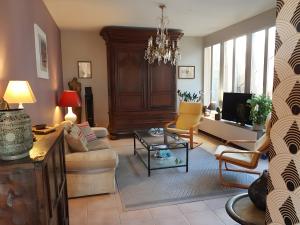 a living room with a couch and a table at Chambre D'hôtes De La Vaine in Cartelègue