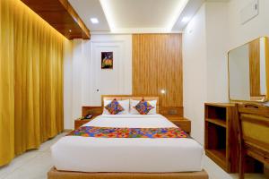 a bedroom with a large bed in a room at FabHotel Prime Hash Four in Ernakulam
