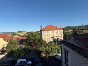 a building with cars parked in a parking lot at Suite Lisa in La Roche-Blanche