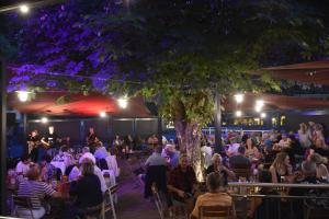 a crowd of people sitting at a restaurant at night at Hotel Gasthof Kamml in Wals +131 photos