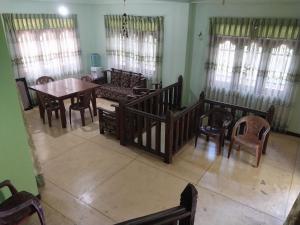 a living room with a table and chairs at Miriswaththa resort in Deniyaya