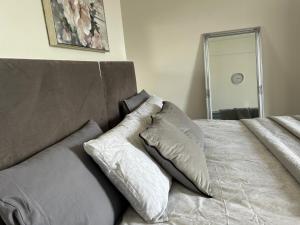 a bedroom with a bed with two pillows on it at Comfortable room in Newbridge