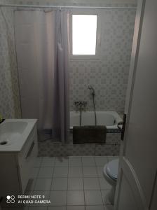 a bathroom with a tub and a toilet and a sink at Appartement Bizerte Nord in Bizerte