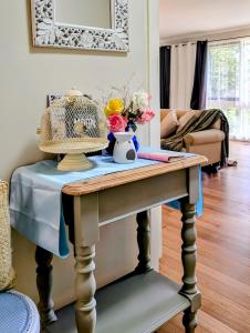 a table with flowers on it in a living room at Star House in Mitcham +5 photos