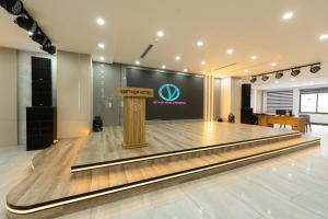 a stage with a podium in the middle of a dance floor at catba new city hotel in Cat Ba +100 photos